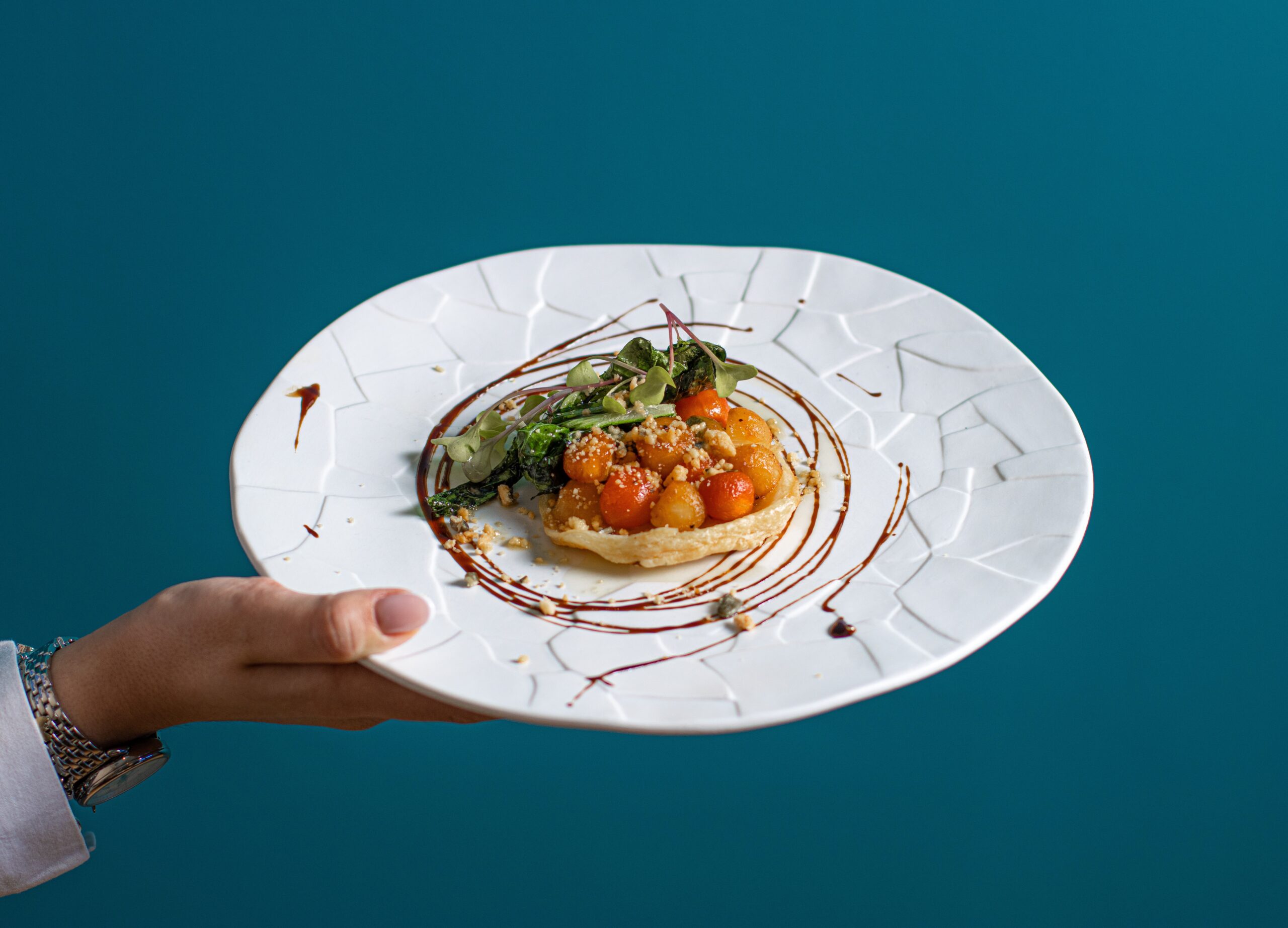 A hand holding a plate of food